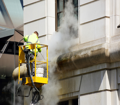 A Worker Washes The Facade